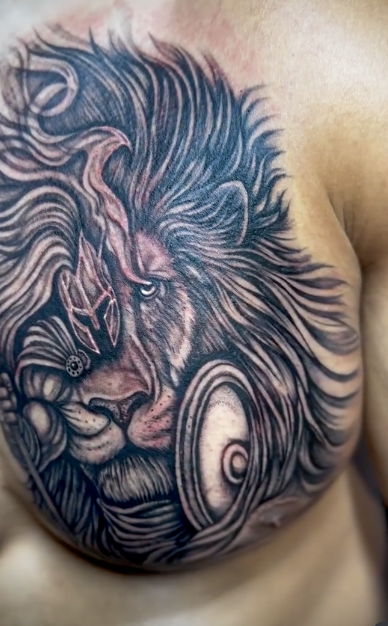 Lion chest tattoo by Ache Hernández